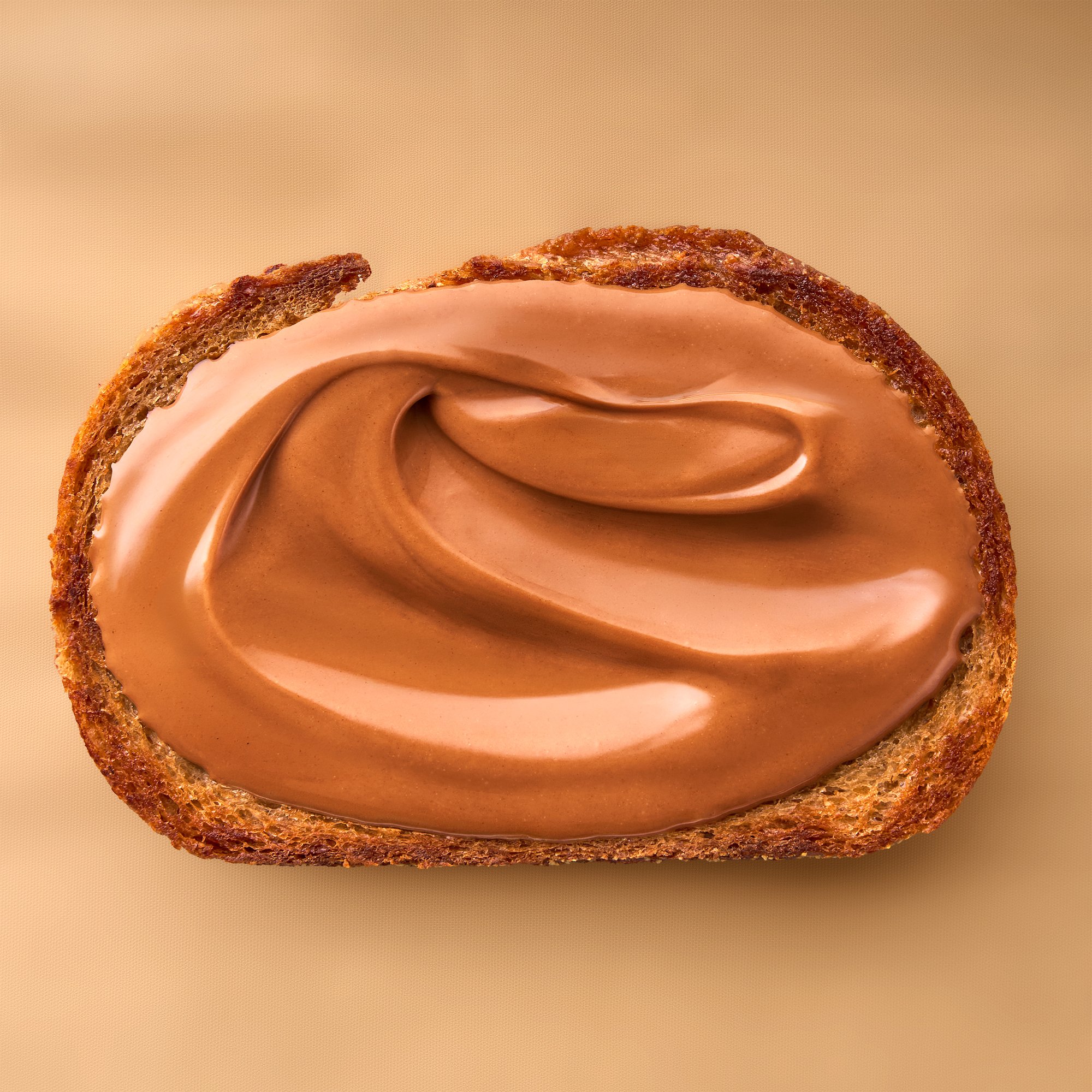 Slice of toast with chocolate spread on beige