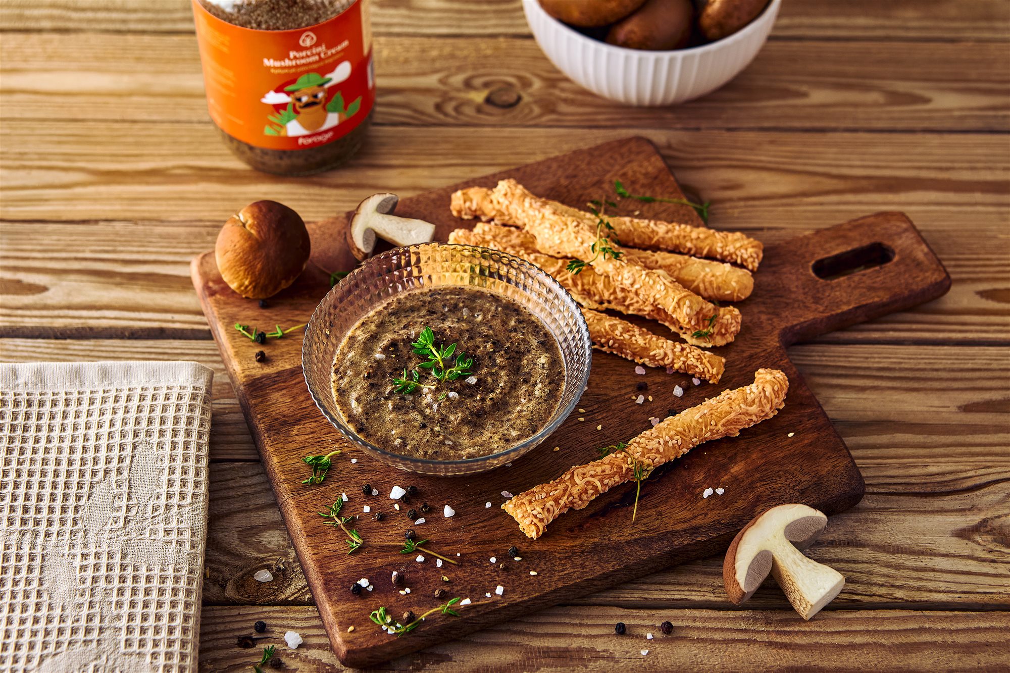 Porcini mushroom cream serving scene with breadsticks and mushrooms