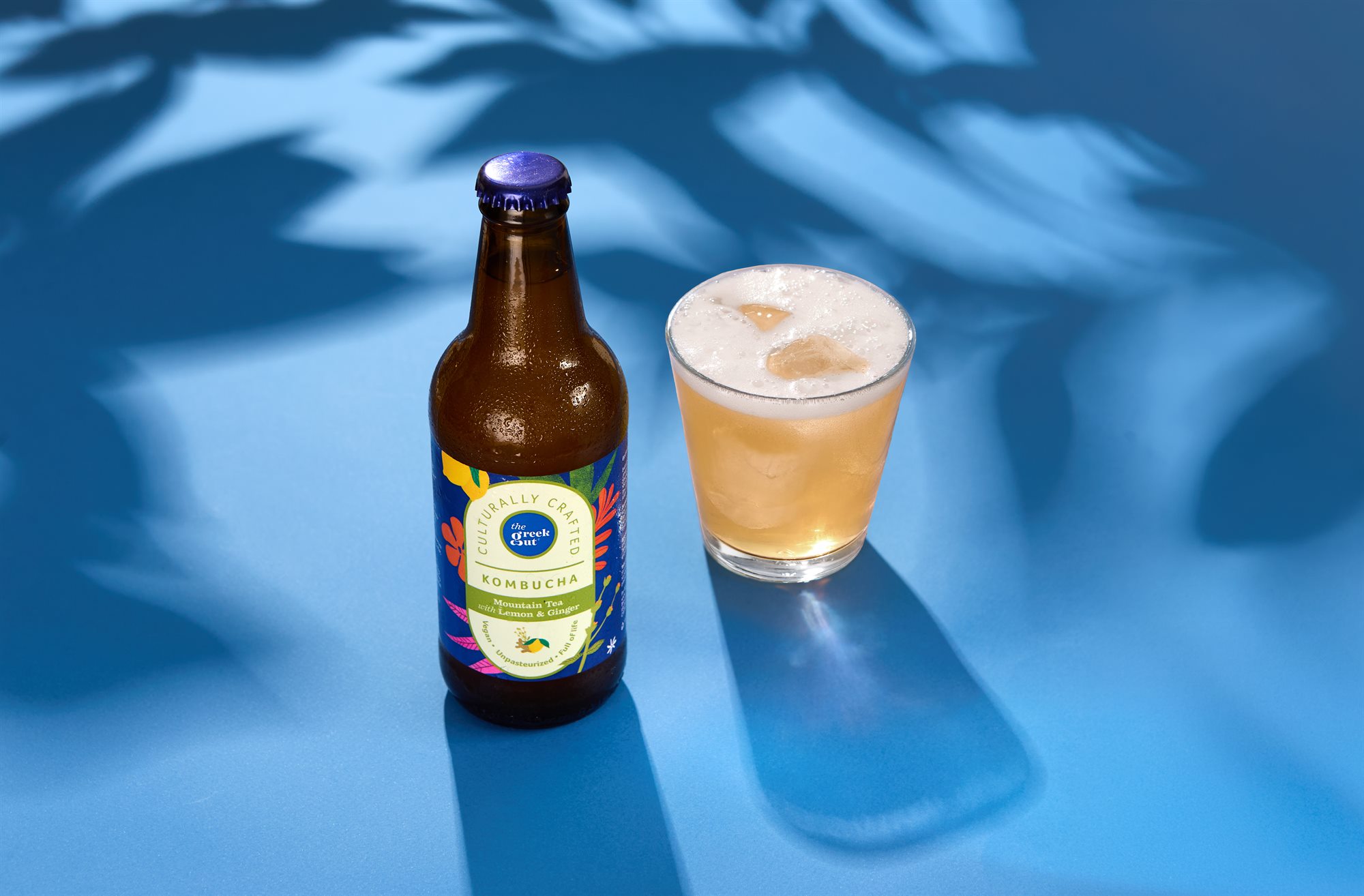 The Greek Gut Mountain Tea Lemon and Ginger kombucha on blue colour background